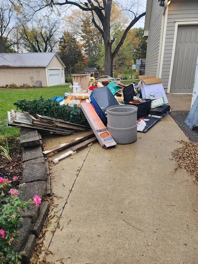 Dumpster being loaded with debris for 12 Yard Dumpster Rental in Hammond